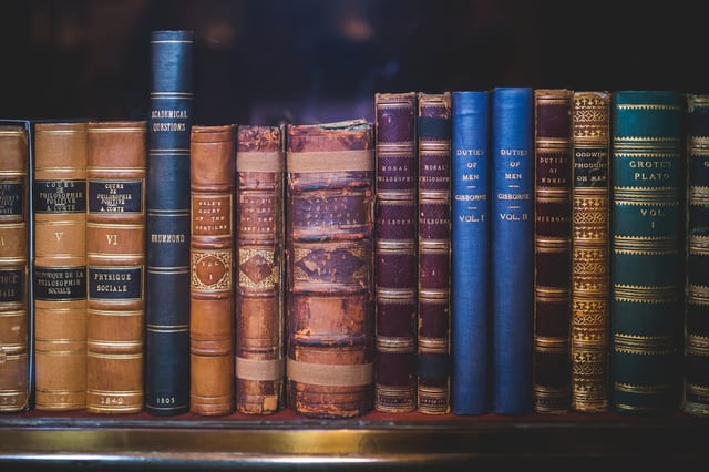 Educational books and journals on shelf in library
