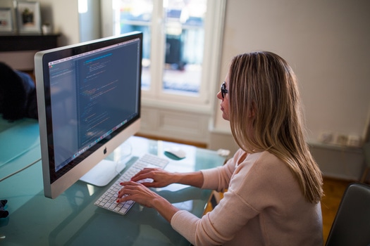 Woman typing on mac