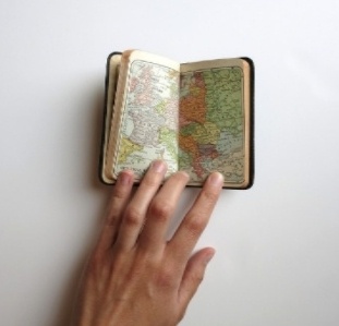 Person looking at map in journal