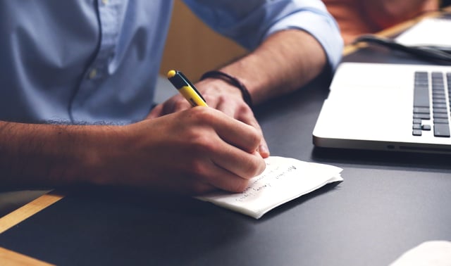 Man writing in notepad