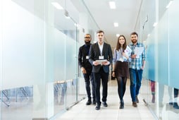 group of people walking in office together