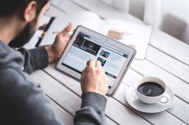 Man completing online learning in coffee shop