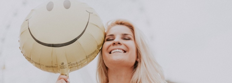 Woman smiling with happy balloon-476188-edited